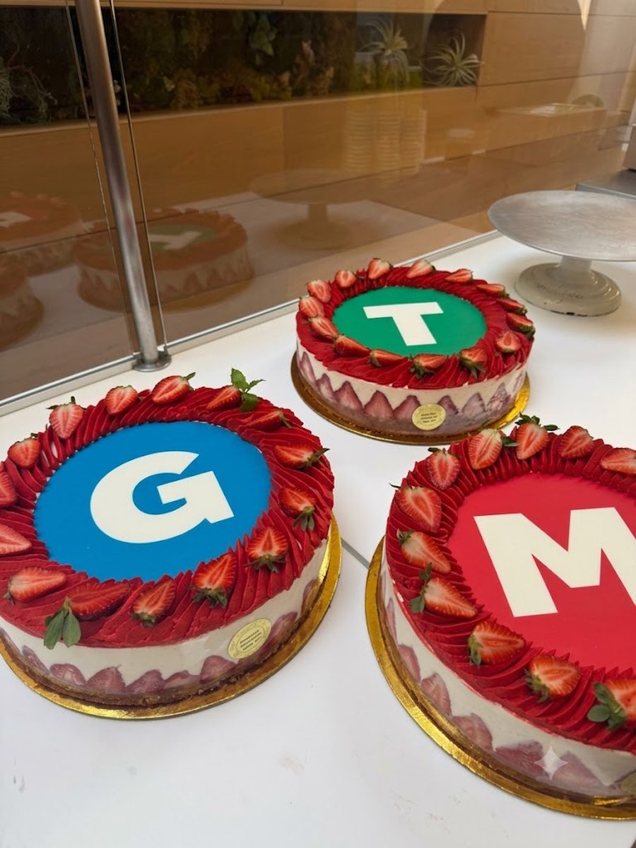 Three cakes, each printed with a different account's brand mark
